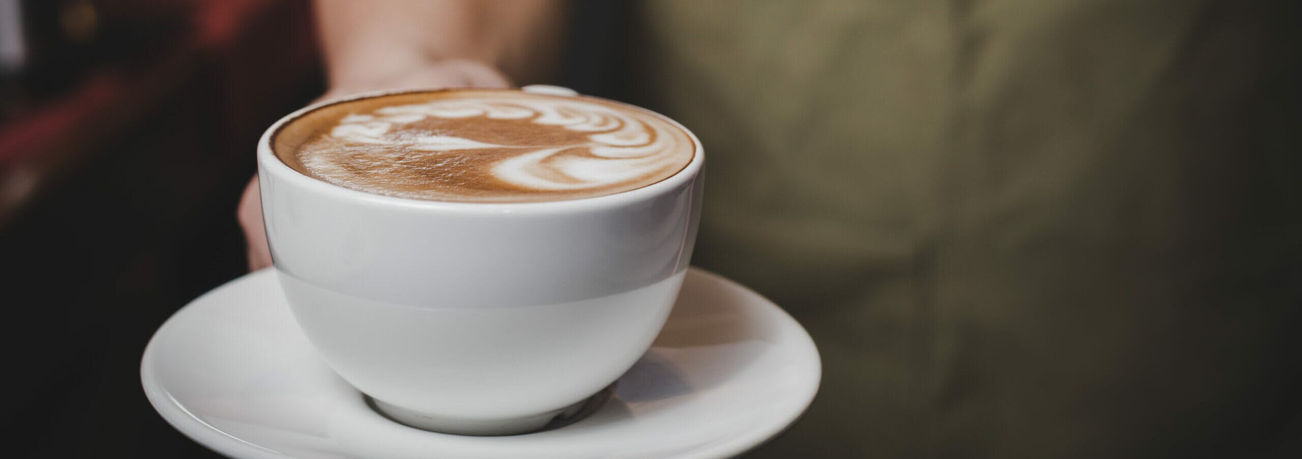 barista-handling-hot-cafe-latte-scaled-e1641816545609.jpg?w=1024&h=361&scale